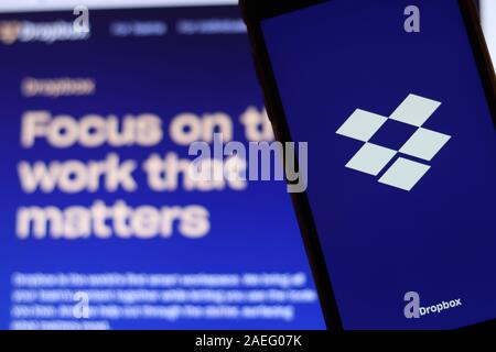 Los Angeles, California, USA - 21 November 2019: Dropbox logo on phone screen with icon on laptop on blurry background, Illustrative Editorial. Stock Photo