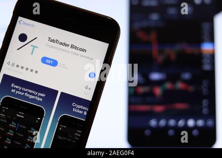 Los Angeles, California, USA - 21 November 2019: TabTrader Bitcoin logo on phone screen with icon on laptop on blurry background, Illustrative Editori Stock Photo