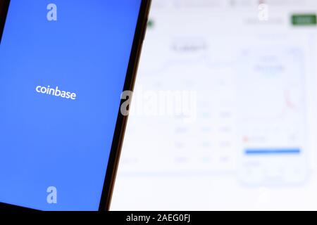 Los Angeles, California, USA - 21 November 2019: Coinbase logo on phone screen with icon on laptop on blurry background, Illustrative Editorial. Stock Photo