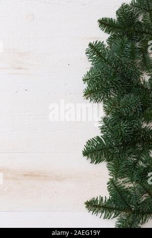 Top view with copy space on Christmas or New Year background: fur-tree on white wooden table. Holidays season. Stock Photo