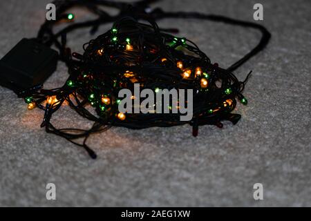 Electric lights need to be unraveled before decorating the christmas tree, isolated. Stock Photo