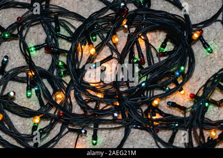 Electric lights need to be unraveled before decorating the christmas tree, isolated. Stock Photo