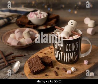 Marshmallow Man Relaxing in a a cup or hot chocolate Stock Photo