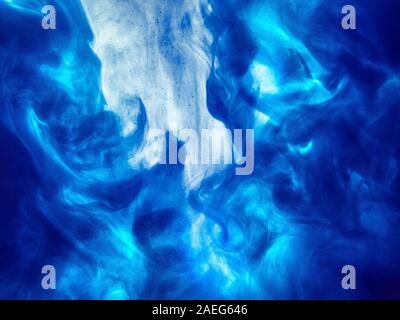 Poster color in water. Abstract background., Color paint drops in water. Ink swirling underwater, Cloud of silky ink collision, abstract smoke explosi Stock Photo