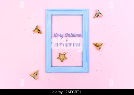 Christmas bell and star with photo frame on pink background Stock Photo