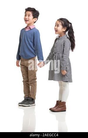 Happy Chinese children holding hands running in woods Stock Photo - Alamy