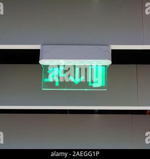 Green glowing emergency exit sign Stock Photo