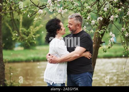 Looking at each other with love. Cheerful couple enjoying nice weekend outdoors. Good spring weather Stock Photo