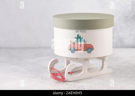 Christmas gift box with holiday car print on wooden sledge Stock Photo