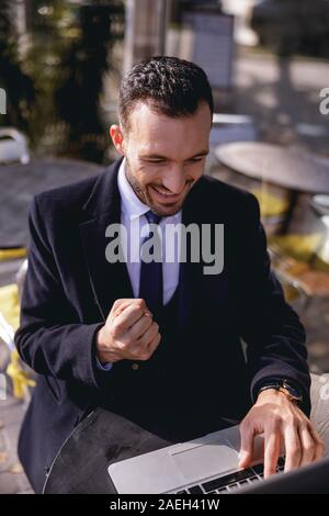 Happy male person having friendly online conversation Stock Photo