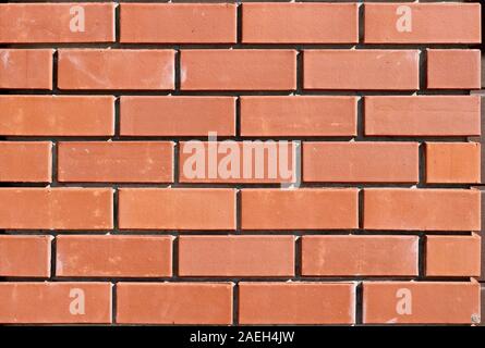 The texture of the new brickwork. Bricks background for design template. Brick wall. Close-up. Stock Photo