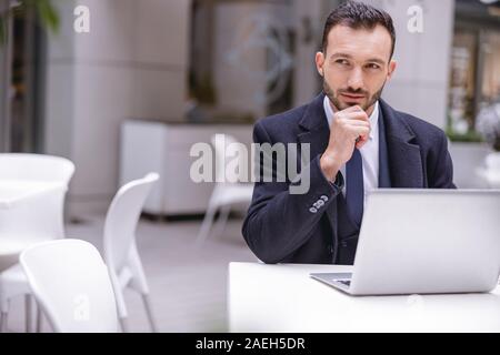 Delighted bearded man waiting for his colleague Stock Photo