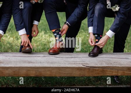 stylish men's socks. Stylish suitcase, men's legs, multicolored socks and new shoes. Concept of style, fashion, beauty and vacation. Stock Photo