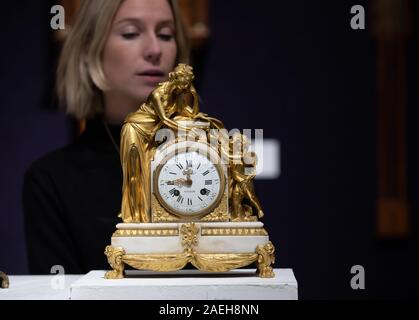 London, UK. 9th Dec, 2019. Bonhams Photocall took place for the Fine Clocks sale. On display a late 18th Century French Ormolu mounted marble clock. Credit: Keith Larby/Alamy Live News