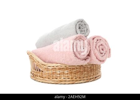 Wicker basket with rolled towels isolated on white background Stock Photo