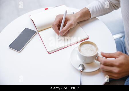 Focused photo on male hand that making notes Stock Photo