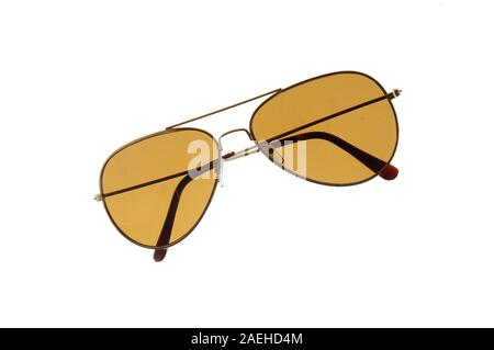 Front view og a pair of yellow-brown colored sunglasses folded isolated on white background. Stock Photo