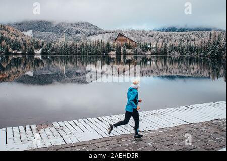 Running in winter, sport photo, beautiful white nature, active man train in winter morning Stock Photo