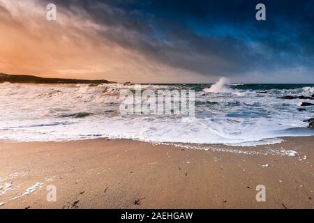 Evening light over Little Fistral as the tide comes in on a windy day in Newquay in Cornwall. Stock Photo