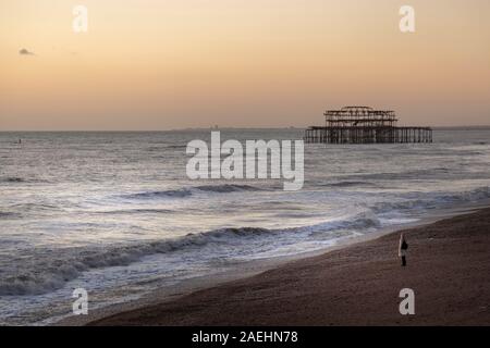 woman at dusk on brighton seafront Stock Photo