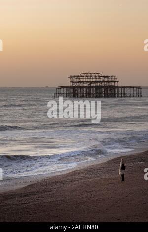 woman at dusk on brighton seafront Stock Photo