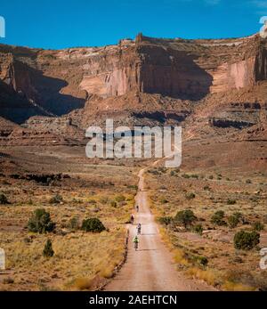 a group of mountain bikers ride the White Rim Trail in Canyonlands National Park. Stock Photo