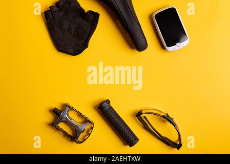 Bicycle, Cycling accessories on the yellow background. view from above Stock Photo