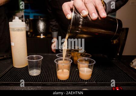 Detail of bartender's hand working in the bar with his shaker and pouring a  cocktail in the glass - a Royalty Free Stock Photo from Photocase