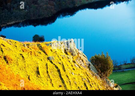 The last rays of evening light catching Nab Scar, looking down on Rydal Water, Lake District, UK. Stock Photo