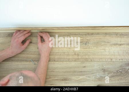 assembly of the molding on a floating floor Stock Photo