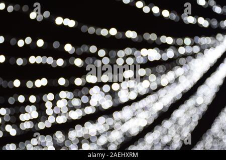 Abstract background white and grey bokeh lights, frozen, winter, cascade of sparks, cold feeling, coldness, silver, sparkling Stock Photo