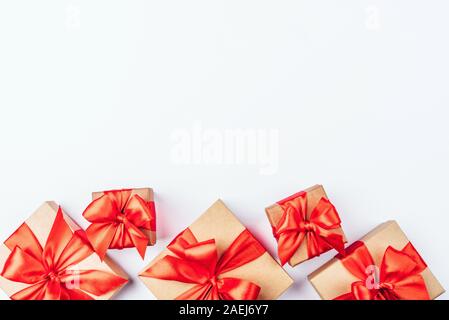 Frame of cardboard gift boxes with red bows. Stock Photo