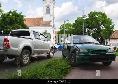 Car crash accident on the city road. Damaged automobiles after collision. Stock Photo