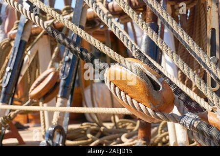 Close-up of a wooden rope pulley and ropes on an old sailing ship Stock Photo