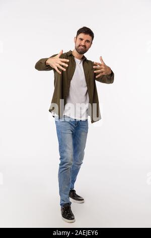 Yo man. Full-length vertical studio shot cool and stylish handsome confident and sassy young bearded man, gesturing with hands as dancing free-style Stock Photo