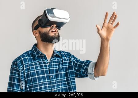 Mature bearded man in virtual reality glasses Stock Photo