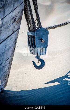 Heavy Duty Rigging Cables Hook at a boat on the beach Stock Photo