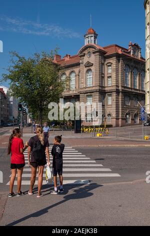 Rear view of pedestrians standing on street in front of Natural History Museum, Helsinki, Finland, Scandinavia, Europe Stock Photo