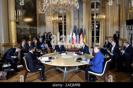 Paris, France. 09th Dec, 2019. The leaders of Ukrainian, France, Russia and Germany take their places for the start of the Normandy Format Summit meeting at the Elysee Palace December 9, 2019 in Paris, France. Sitting from left to right are: Ukraine President Vladimir Zelensky, French President Emmanuel Macron, Russian President Vladimir Putin and German Chancellor Angela Merkel. Credit: Alexei Nikolsky/Kremlin Pool/Alamy Live News