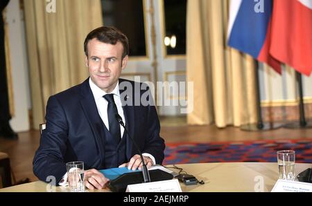 Paris, France. 09th Dec, 2019. French President Emmanuel Macron prepares for the start of the Normandy Format Summit meeting at the Elysee Palace December 9, 2019 in Paris, France. The summit is attended hosted by Macron and German Chancellor Angela Merkel in an effort to find an end to the war in Ukraine. Credit: Alexei Nikolsky/Kremlin Pool/Alamy Live News
