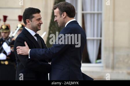 Paris, France. 09th Dec, 2019. French President Emmanuel Macron, right, welcomes Ukrainian President Vladimir Zelensky to the Elysee Palace December 9, 2019 in Paris, France. Zelensky is in Paris for the Normandy Format Summit in an effort to find an end to the war in Ukraine. Credit: Alexei Nikolsky/Kremlin Pool/Alamy Live News