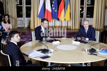 Paris, France. 09th Dec, 2019. The leaders of Ukrainian, France and Russia take their places for the start of the Normandy Format Summit meeting at the Elysee Palace December 9, 2019 in Paris, France. Sitting from left to right are: Ukraine President Vladimir Zelensky, French President Emmanuel Macron, and Russian President Vladimir Putin. Credit: Alexei Nikolsky/Kremlin Pool/Alamy Live News