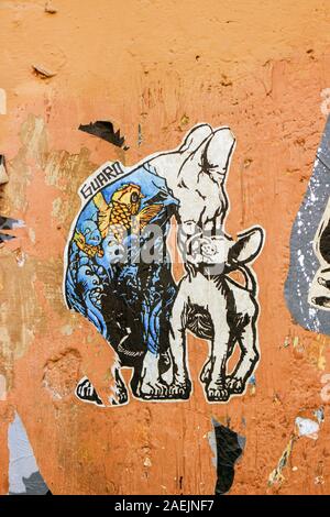 Cut-to-shape paste-up poster art by Guaro on wall in Trastevere district of Rome, Italy Stock Photo