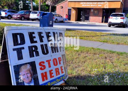 Melbourne Beach, Florida. USA. December 9, 2019, Out of state, LaRouche  PAC group sets up information tables and tent with home-made signs in front of the Melbourne Beach Post Office to spread their message and collect petition signatures in support of President Trump.  Photo Credit Julian Leek / Alamy Live News Stock Photo