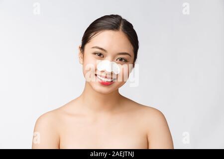 Cosmetology. Portrait Of Beautiful Female Asian Model With Mask On Nose. Closeup Of Healthy Young Woman With Pure Soft Skin And Fresh Natural Makeup. Stock Photo