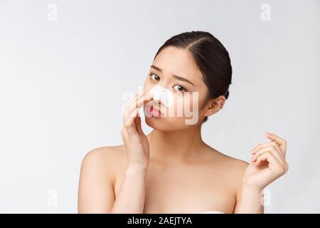 Cosmetology. Portrait Of Beautiful Female Asian Model With Mask On Nose. Closeup Of Healthy Young Woman With Pure Soft Skin And Fresh Natural Makeup. Stock Photo