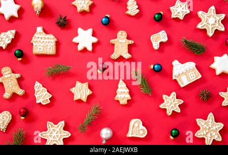 Gingerbread cookies with Christmas decorati on red background Stock Photo