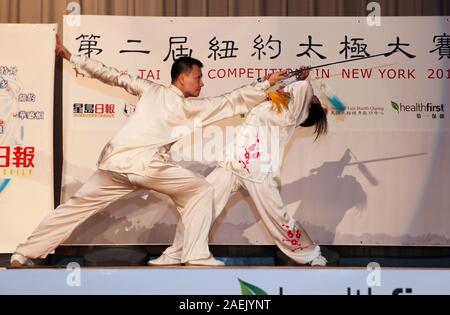 New York, USA. 9th Dec, 2019. Chen Sitan (L) and his wife Lin Xu perform at the 2nd Tai Chi competition in New York, the United States, Nov. 18, 2012. The ancient Chinese martial art Tai Chi has increasingly become a form of life for many New Yorkers, thanks to the efforts made by former world martial art champion Chen Sitan and his wife Lin Xu.TO GO WITH 'Feature: Former world champion brings Tai Chi into New Yorkers' life' Credit: Xinhua/Alamy Live News Stock Photo