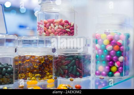 Supplements and pills in clear glass bottle for sale at pharmacy drug store Stock Photo