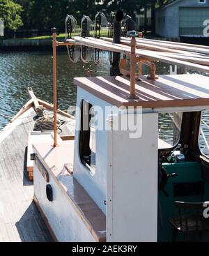 A clamboat with three tongs on top is ready to go out to the bay for another hard day of work on Long Island. Stock Photo